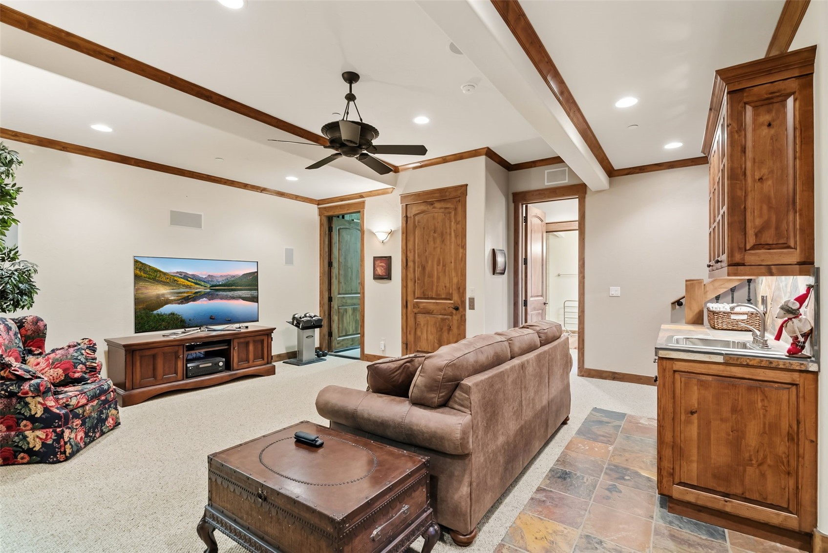 2140 Hunter's Knob Road Silverthorne, CO 80498 - Photo 27 of 46 Living room featuring crown molding, a ceiling fan, light carpet, recessed lighting, and beam ceiling
