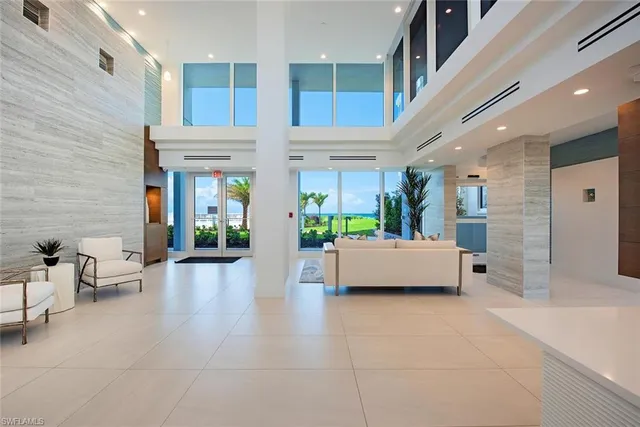 a lobby with furniture and a potted plant