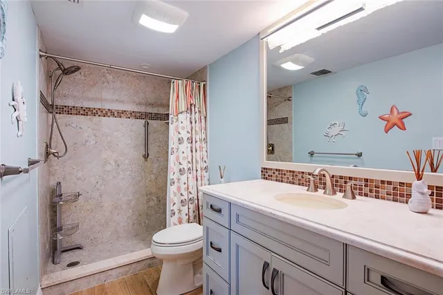 a bathroom with a sink toilet and shower