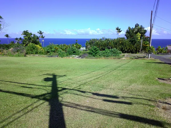a view of a golf course with an ocean view