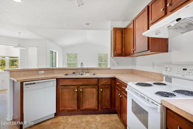 a kitchen with a sink stove and cabinets