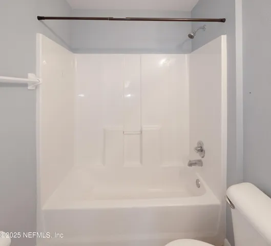 a bathroom with a shower and a bath tub