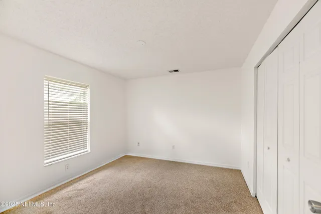 a view of house with patio outdoor seating and green space