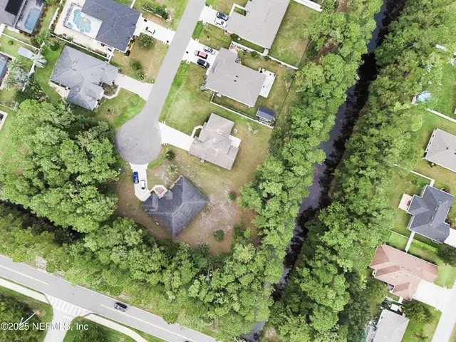 an aerial view of a house with garden space and street view