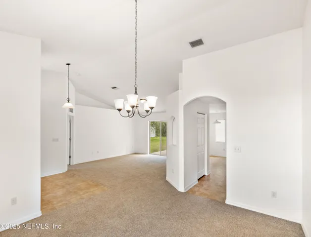 a view of a chandelier in big room and chandelier fan