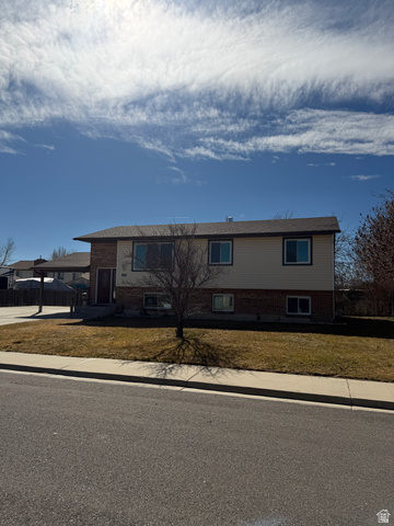 1259 West Raintree Drive Price, UT 84501 - Photo 10 of 10 View of front facade featuring brick siding and a front yard