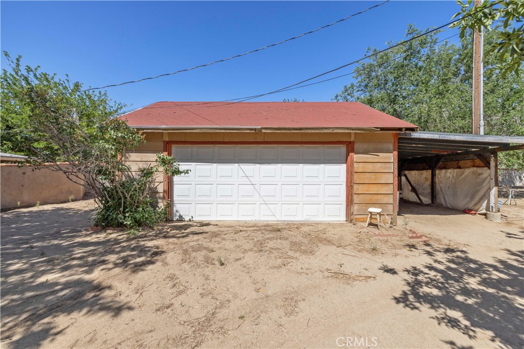 15374 Gaskell Road Rosamond, CA 93560 - Photo 14 of 74 a front view of a house with a yard and garage