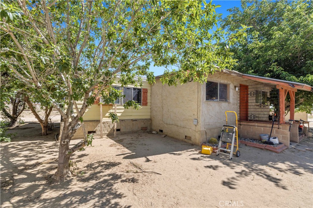 15374 Gaskell Road Rosamond, CA 93560 - Photo 15 of 74 a backyard of a house with barbeque oven fire pit table and chairs