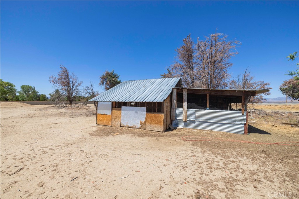 15374 Gaskell Road Rosamond, CA 93560 - Photo 27 of 74 a front view of a house with a yard