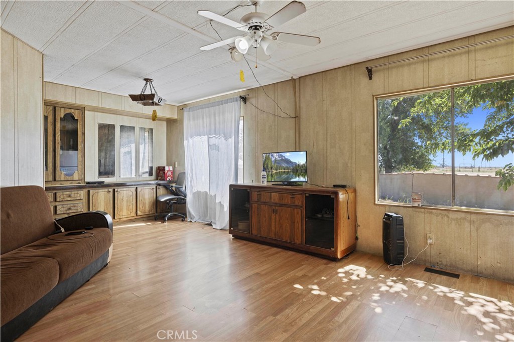 15374 Gaskell Road Rosamond, CA 93560 - Photo 29 of 74 a living room with furniture and a chandelier