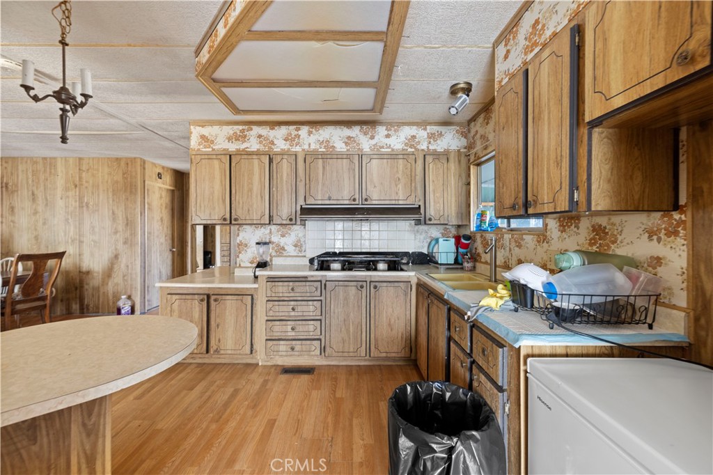 15374 Gaskell Road Rosamond, CA 93560 - Photo 31 of 74 a kitchen with a sink cabinets and window