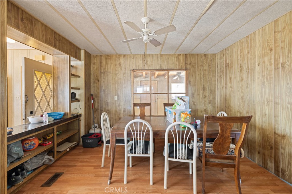 15374 Gaskell Road Rosamond, CA 93560 - Photo 33 of 74 a view of a dining room with furniture window and wooden floor
