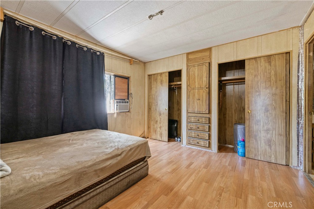 15374 Gaskell Road Rosamond, CA 93560 - Photo 36 of 74 a spacious bedroom with a bed and wooden floor