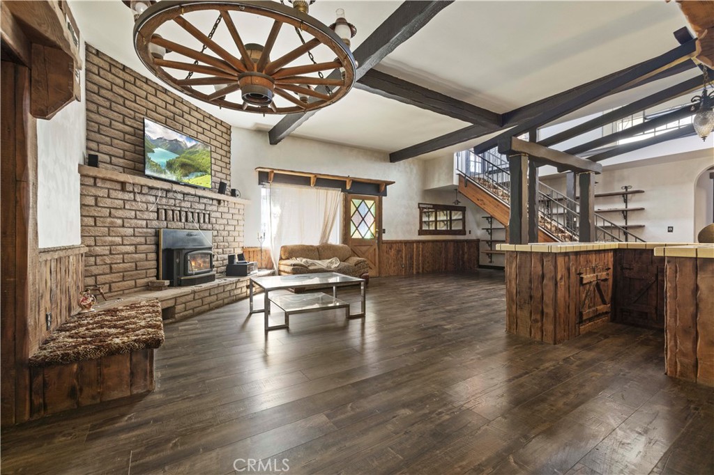 15374 Gaskell Road Rosamond, CA 93560 - Photo 48 of 74 a living room with fireplace furniture and a wooden floor