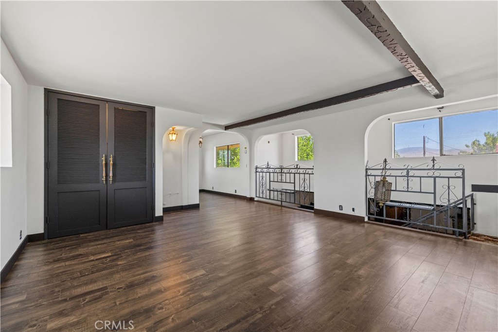 15374 Gaskell Road Rosamond, CA 93560 - Photo 51 of 74 an empty room with wooden floor and windows