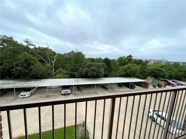 a kitchen with a counter space wooden floor and a ceiling fan
