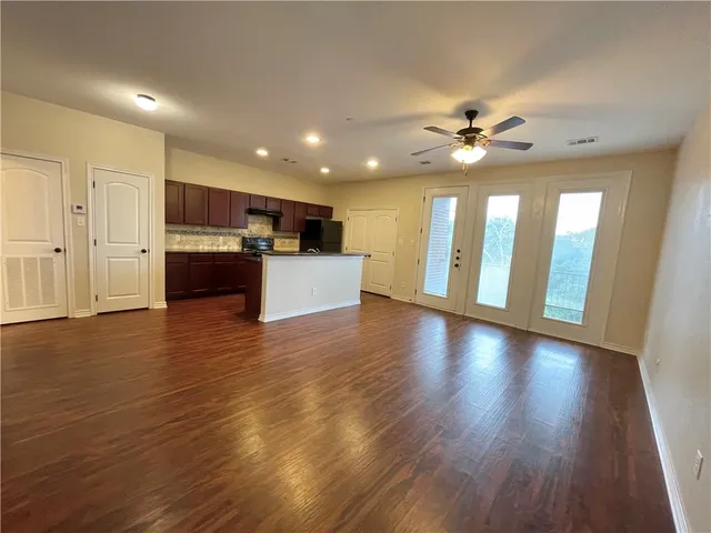 a view of a kitchen with a sink and a stove top oven