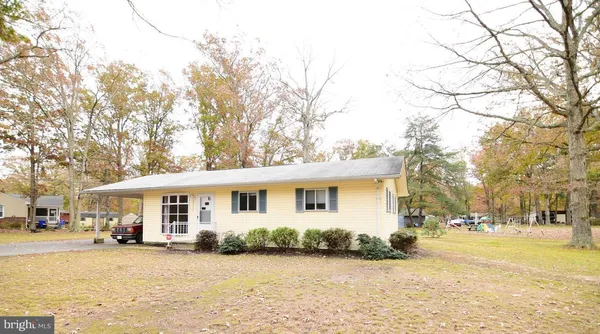 a front view of a house with yard and garage