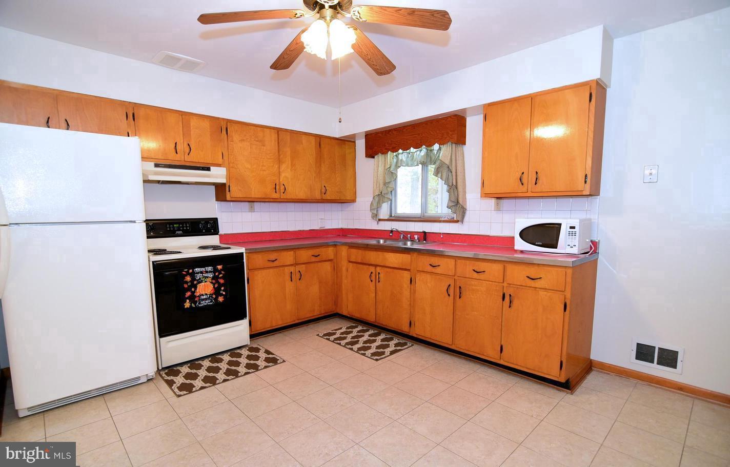 5210 Colebrook Drive La Plata, MD 20646 - Photo 13 of 27 a kitchen with a sink cabinets and window