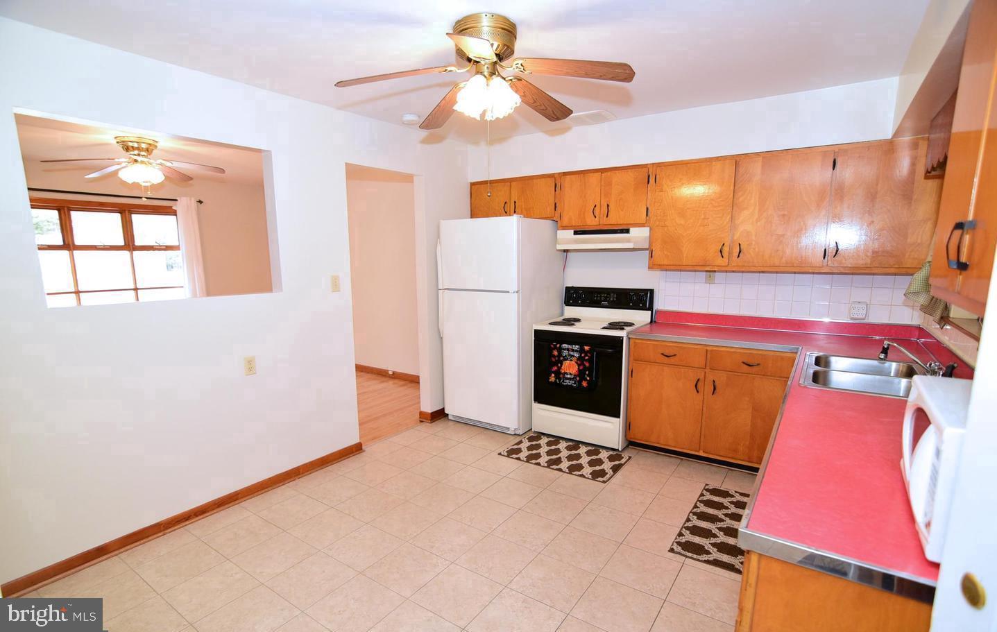 5210 Colebrook Drive La Plata, MD 20646 - Photo 14 of 27 a kitchen with a stove a refrigerator and a chandelier