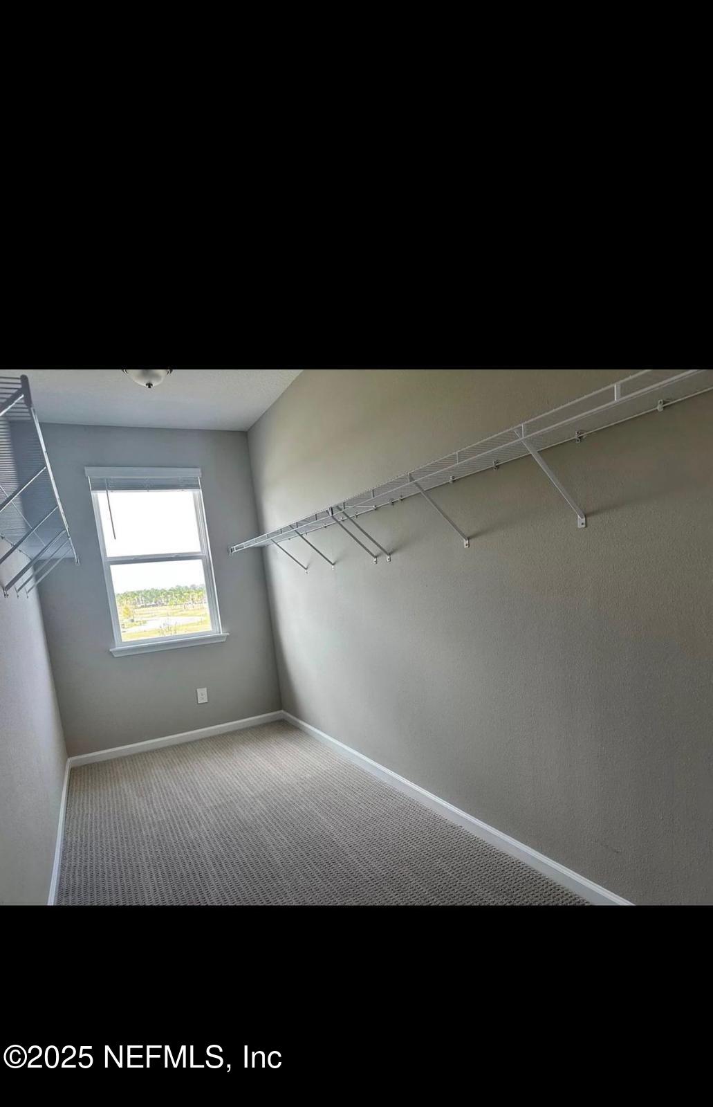 213 Silver Myrtle Court St. Augustine, FL 32092 - Photo 12 of 25 a view of an empty room with a window