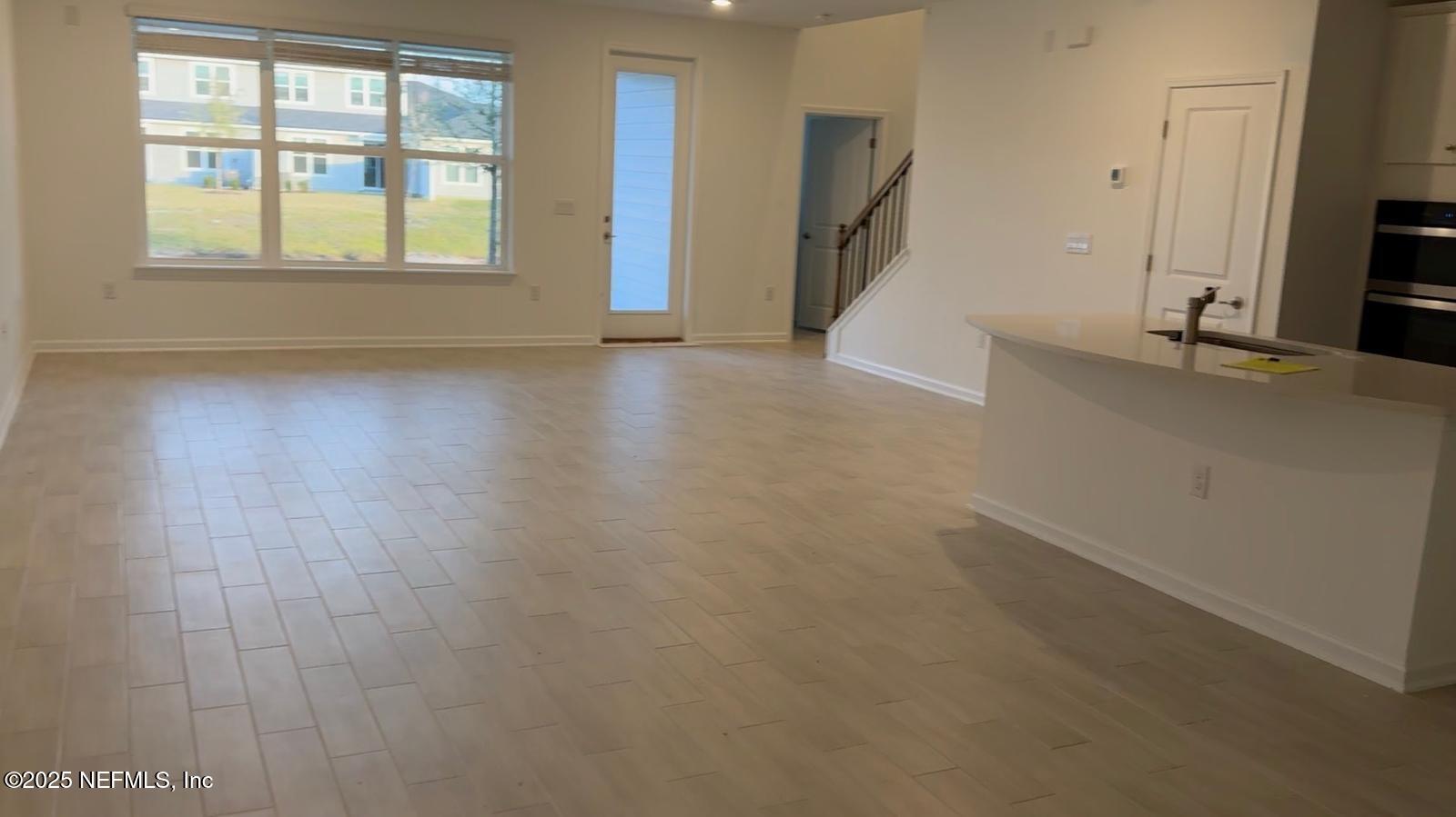 213 Silver Myrtle Court St. Augustine, FL 32092 - Photo 3 of 25 wooden floor in an empty room with a window