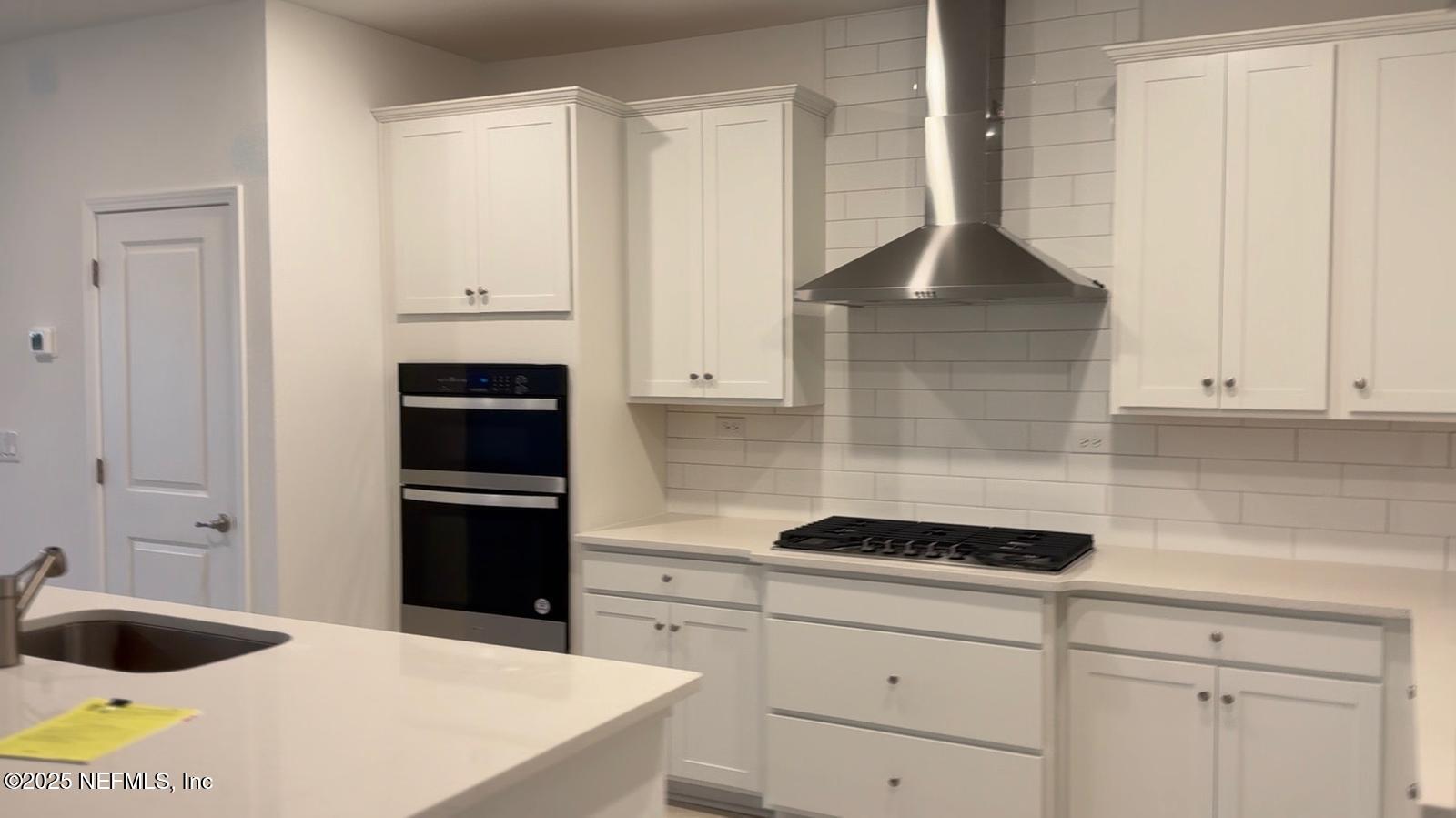 213 Silver Myrtle Court St. Augustine, FL 32092 - Photo 4 of 25 a kitchen with a cabinets and appliances