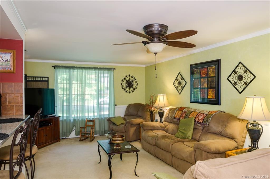 4823 Smokehollow Road Charlotte, NC 28227 - Photo 11 of 19 a living room with furniture a ceiling fan and a flat screen tv