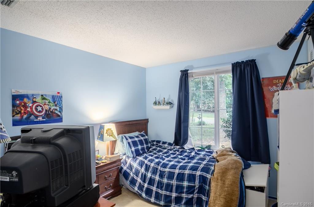 4823 Smokehollow Road Charlotte, NC 28227 - Photo 14 of 19 a bedroom with a bed and glass window
