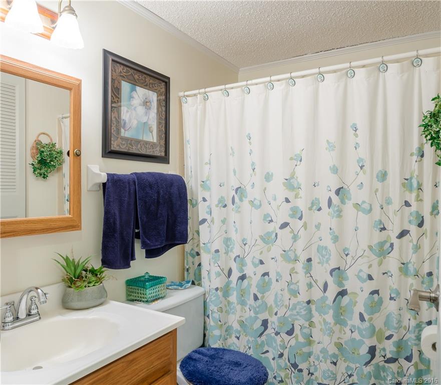 4823 Smokehollow Road Charlotte, NC 28227 - Photo 17 of 19 a bathroom with a sink and a mirror