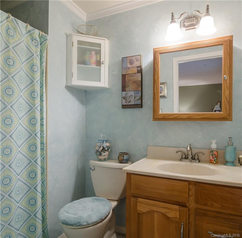 4823 Smokehollow Road Charlotte, NC 28227 - Photo 7 of 19 a bathroom with a toilet a sink and mirror