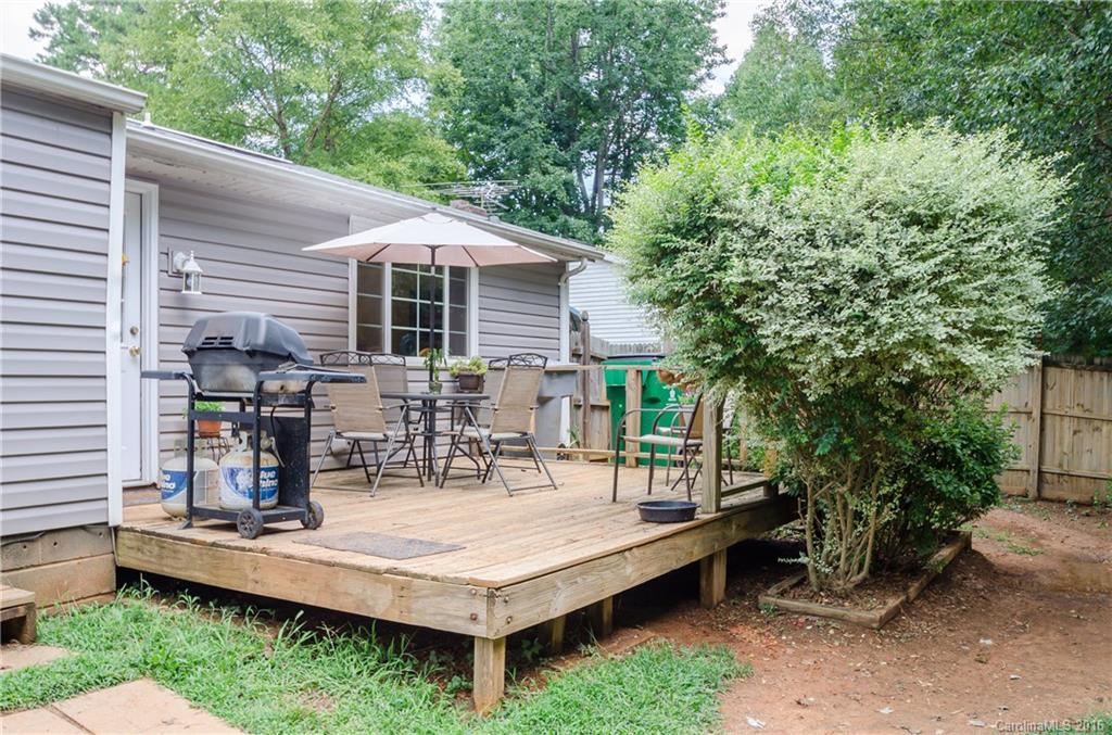 4823 Smokehollow Road Charlotte, NC 28227 - Photo 9 of 19 a view of a patio with table and chairs potted plants and large tree