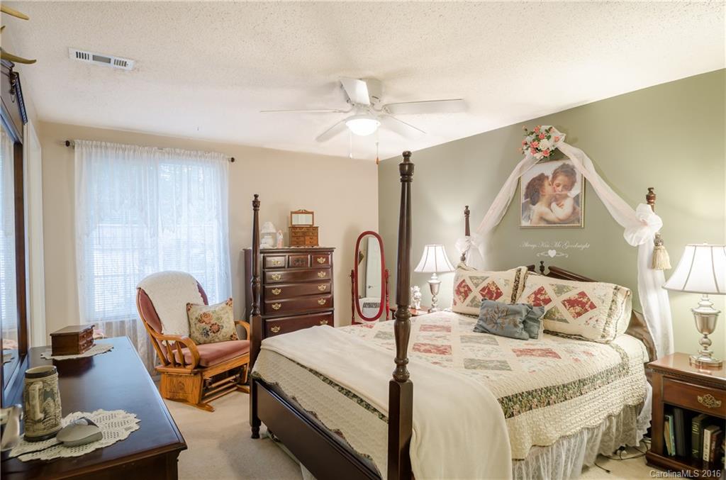 4823 Smokehollow Road Charlotte, NC 28227 - Photo 10 of 19 a bedroom with a bed a couch and dresser