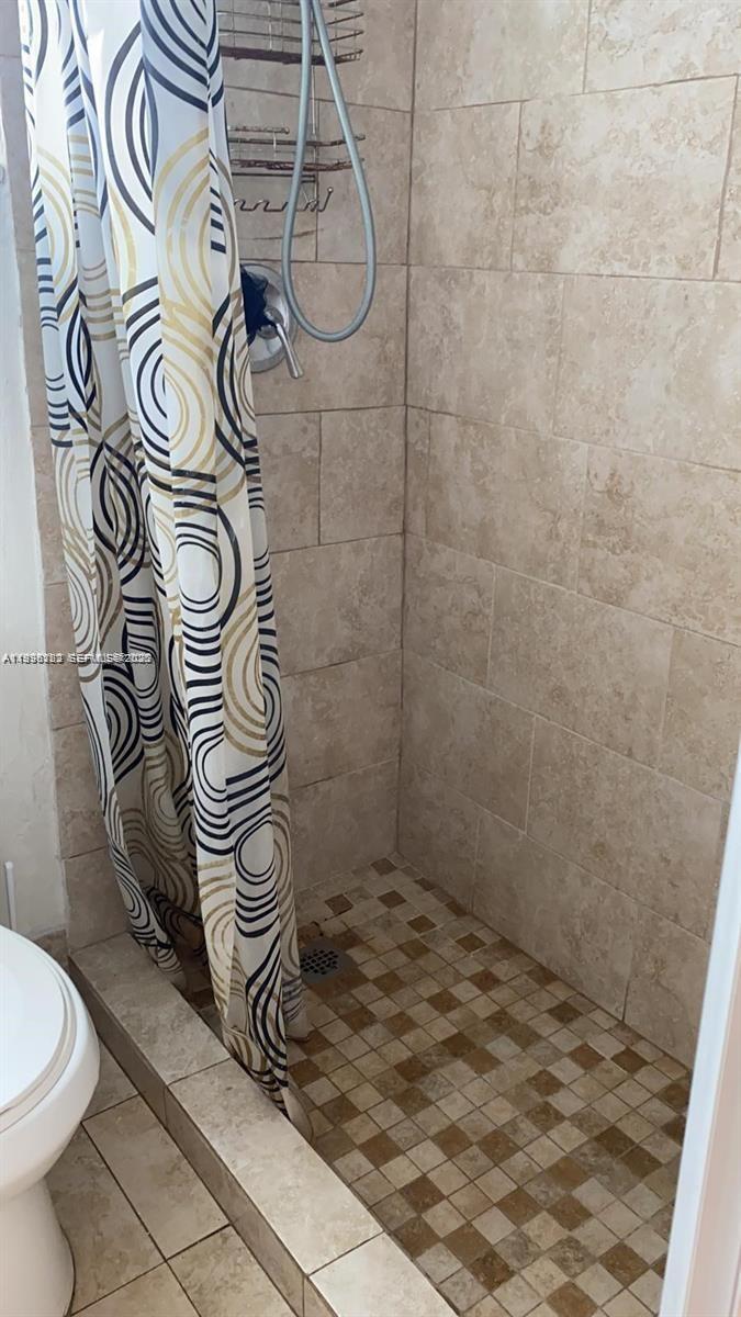 1220 71st Street, Unit 38 Miami Beach, FL 33141 - Photo 11 of 22 a bathroom with a shower and a toilet