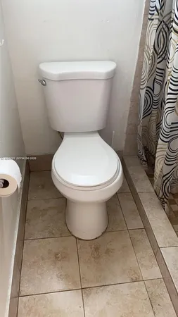 a white toilet sitting next to a bathroom sink