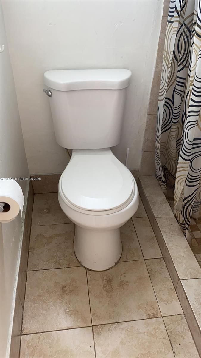 1220 71st Street, Unit 38 Miami Beach, FL 33141 - Photo 12 of 22 a white toilet sitting next to a bathroom sink