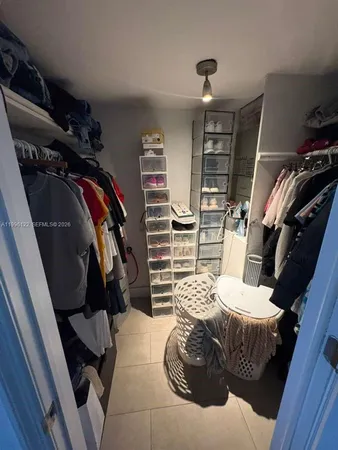 a bedroom with a bed and walk in closet