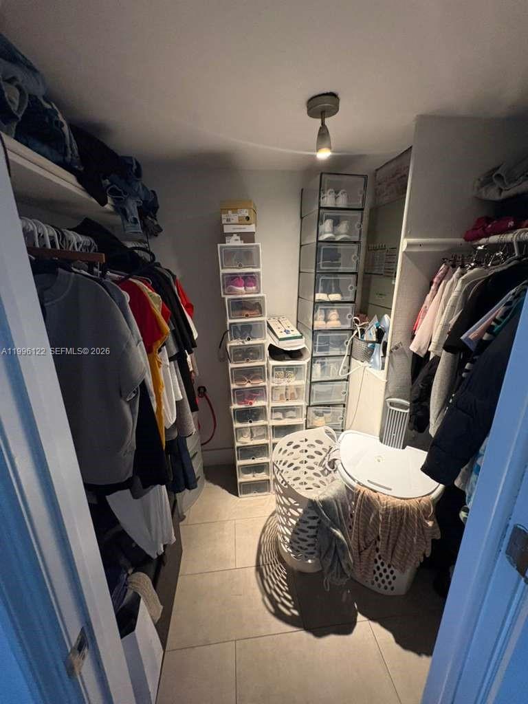 1220 71st Street, Unit 38 Miami Beach, FL 33141 - Photo 13 of 22 a bedroom with a bed and walk in closet