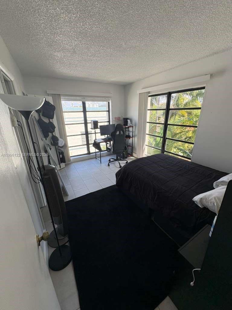 1220 71st Street, Unit 38 Miami Beach, FL 33141 - Photo 14 of 22 a view of a workspace with furniture and a window