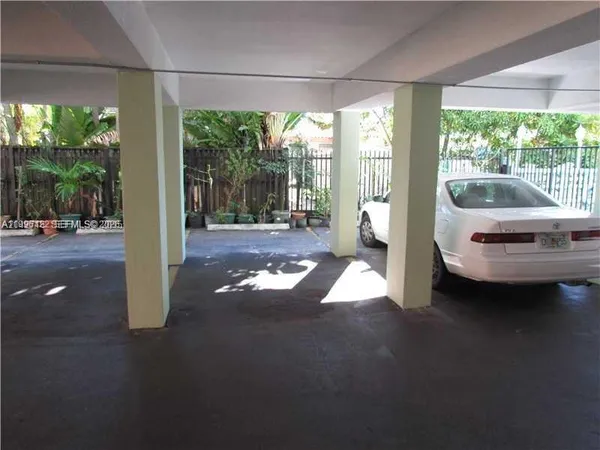 a living room with furniture and large windows