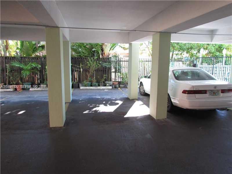 1220 71st Street, Unit 38 Miami Beach, FL 33141 - Photo 18 of 22 a living room with furniture and large windows