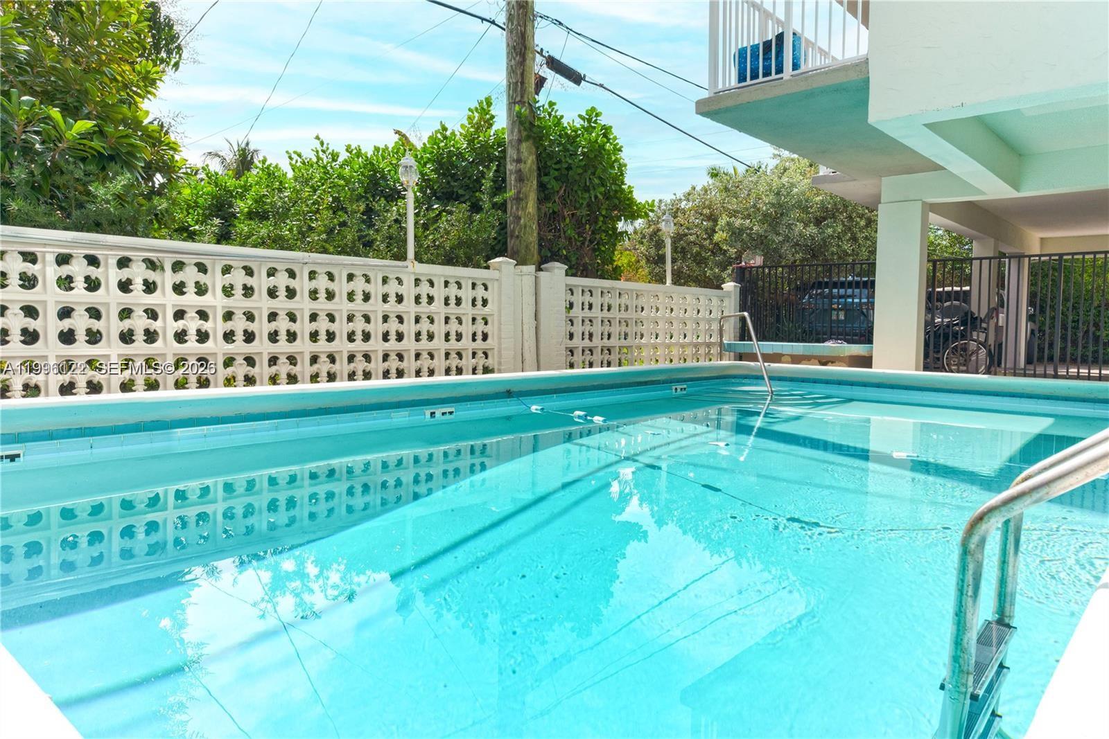 1220 71st Street, Unit 38 Miami Beach, FL 33141 - Photo 19 of 22 a view of a yard with wooden fence