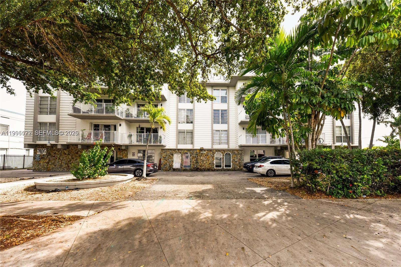 1220 71st Street, Unit 38 Miami Beach, FL 33141 - Photo 2 of 22 a view of a house with a tree in front of it