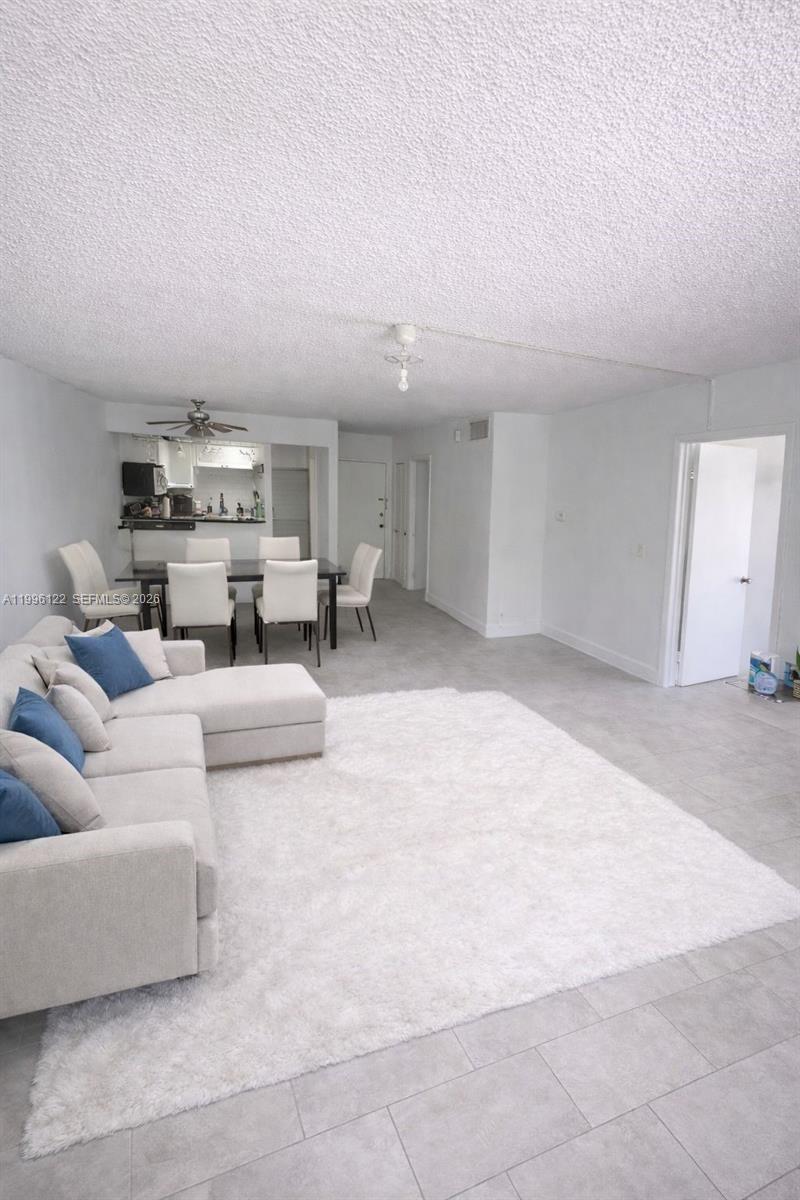 1220 71st Street, Unit 38 Miami Beach, FL 33141 - Photo 4 of 22 a living room with furniture and a couch