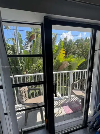 a view of a room with wooden floor and furniture