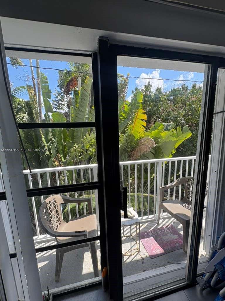 1220 71st Street, Unit 38 Miami Beach, FL 33141 - Photo 6 of 22 a view of a room with wooden floor and furniture