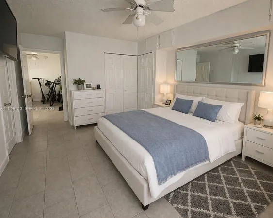 a bedroom with a bed and a view of bathroom