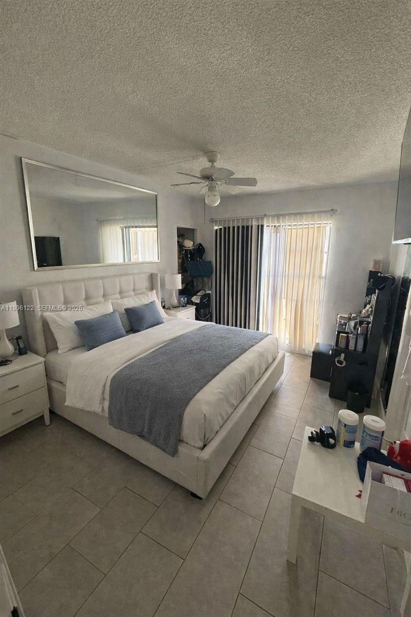 1220 71st Street, Unit 38 Miami Beach, FL 33141 - Photo 9 of 22 a bedroom with a bed and furniture