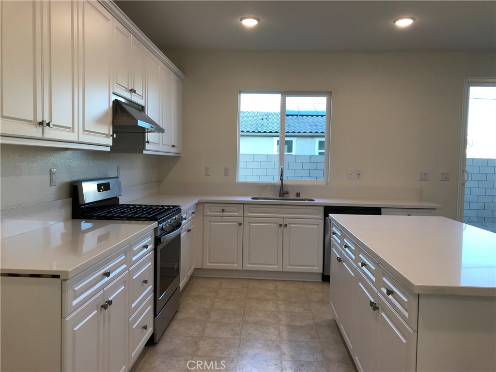 16031 Cordova Road Victorville, CA 92394 - Photo 12 of 34 a kitchen that has a sink and a stove