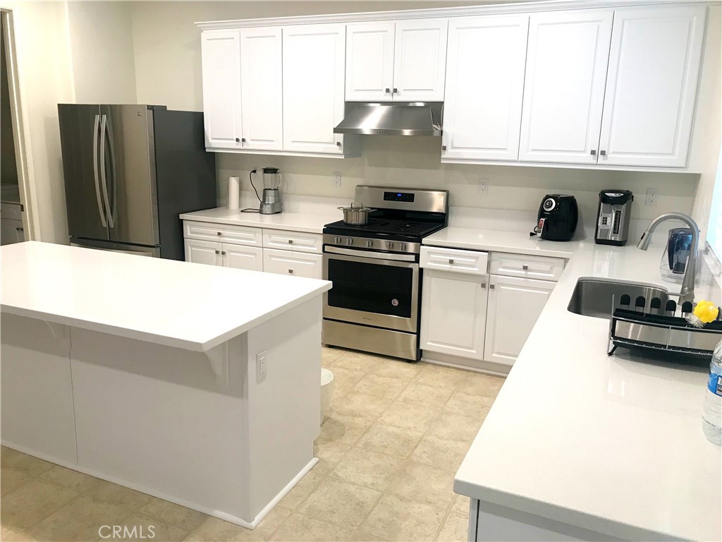 16031 Cordova Road Victorville, CA 92394 - Photo 13 of 34 a kitchen with stainless steel appliances granite countertop a refrigerator stove top oven a sink and dishwasher